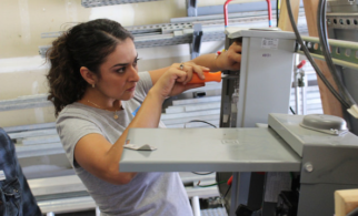 April Valdez practicing on an electrical junction box during Solar Training Academy.