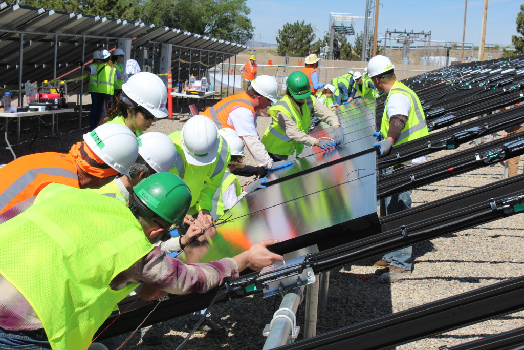 A group of people working on a community solar array. 