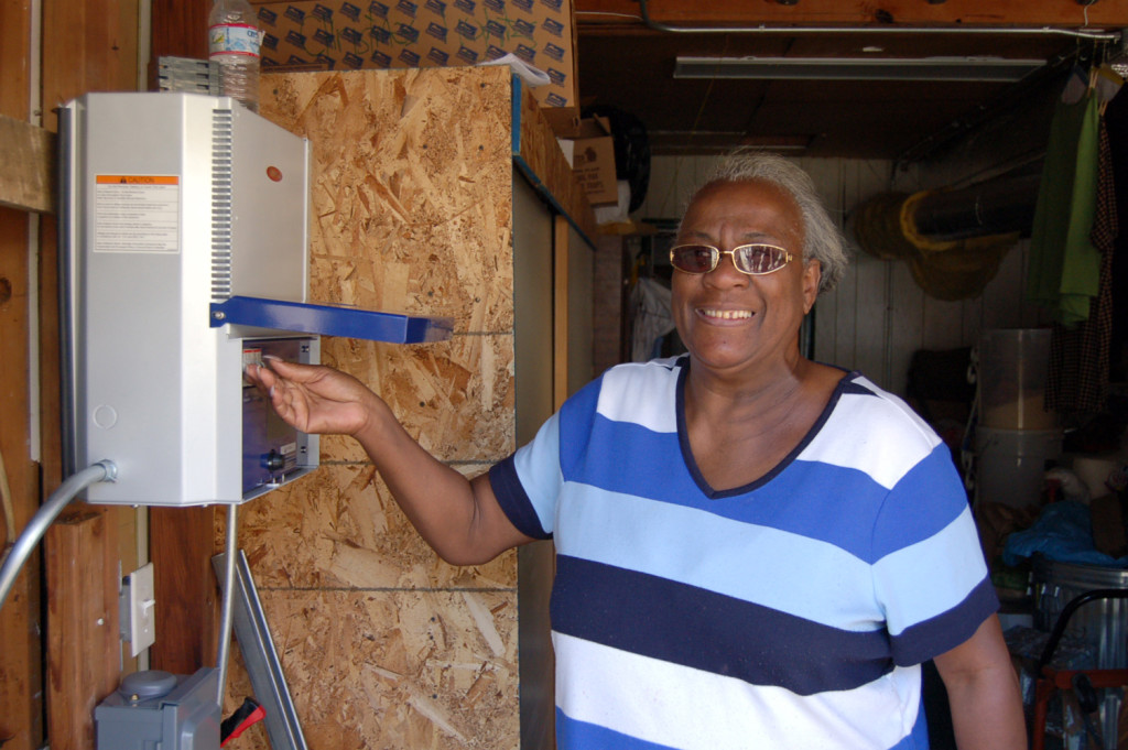 A smiling homeowner turns on the switch to her solar. 