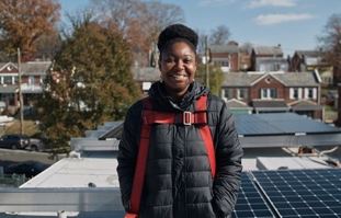 LaToya Smith stands in front of her newly installed solar system.